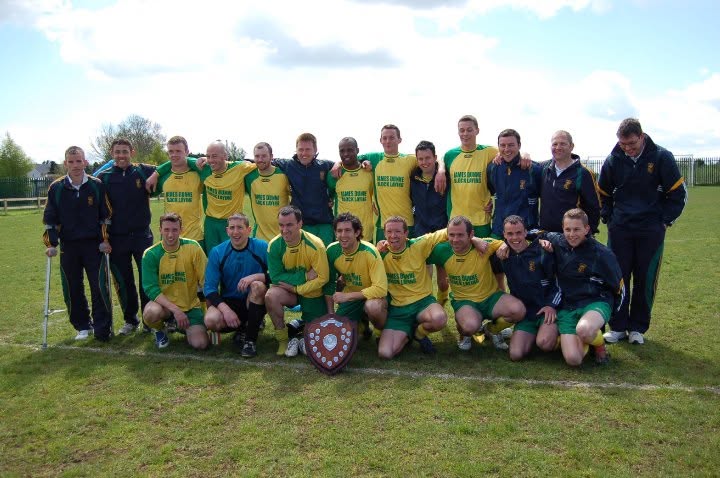 Crettyard United squad and management with the shield in James Dunne Block Laying kit