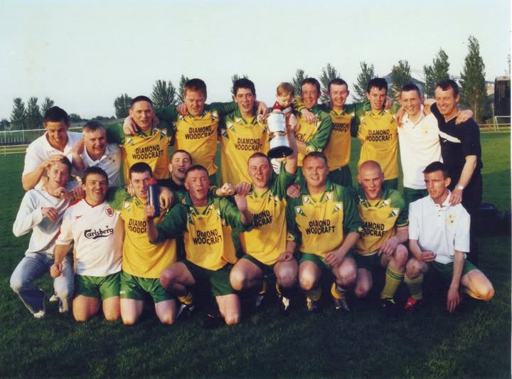 Crettyard United squad in Diamond Woodcraft kit celebrating with the cup