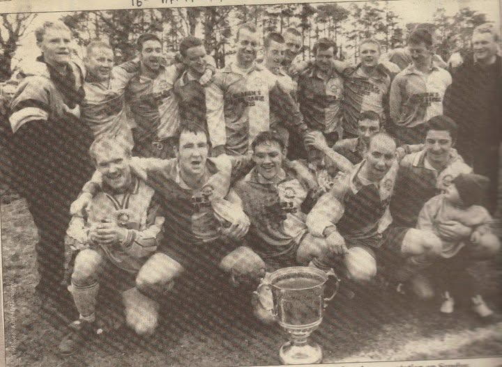 Crettyard United team celebrating with a cup in Graham's Free Range Eggs kit