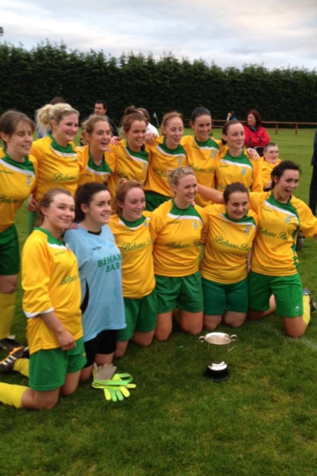 Crettyard United ladies team celebrating with a cup on the pitch