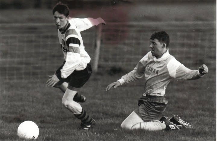 Winger breaking away from a sliding defender