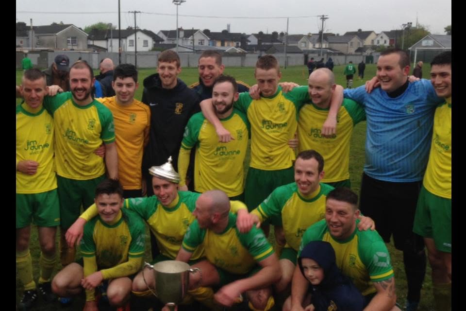 Crettyard United squad celebrating with the cup in Jim Dunne Electrical kit