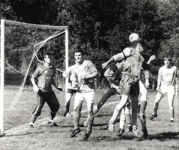 Crowded goalmouth as players rise for a header