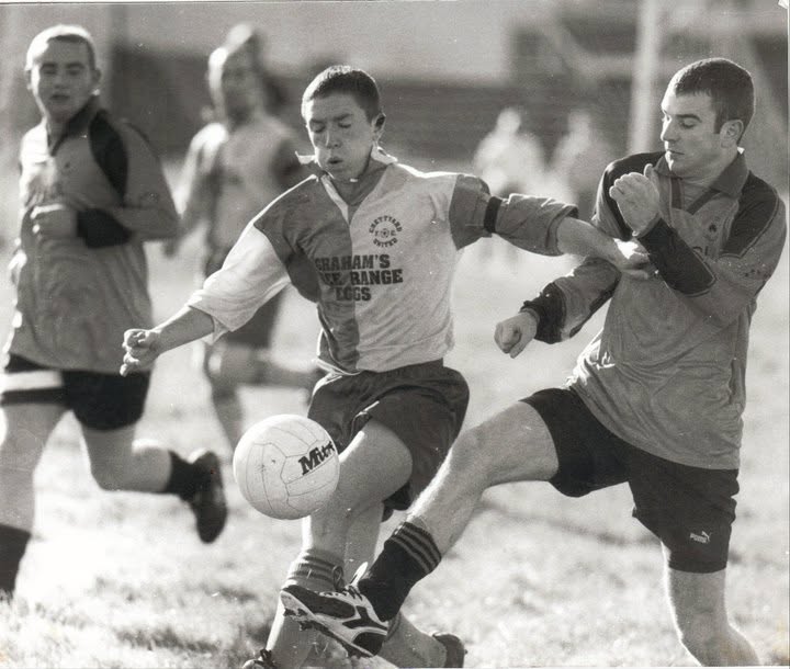 Crettyard United player challenging for the ball, black and white photo