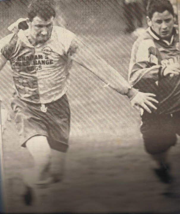Crettyard United player in Graham's Free Range Eggs kit driving forward