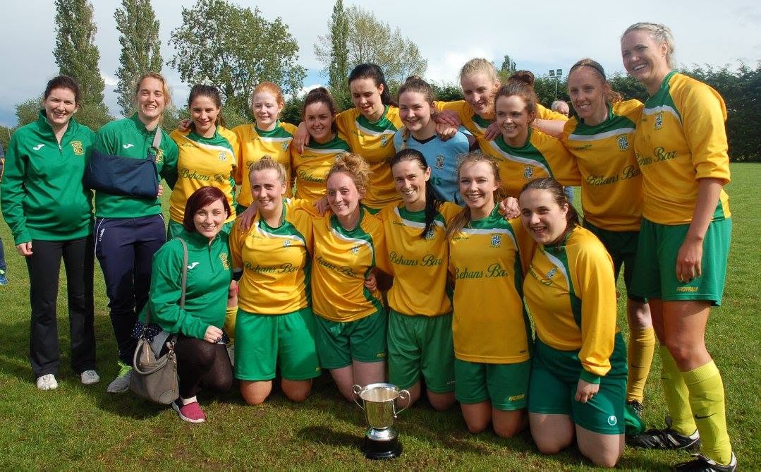 Crettyard United ladies team celebrating with the cup in Behans Bar kit
