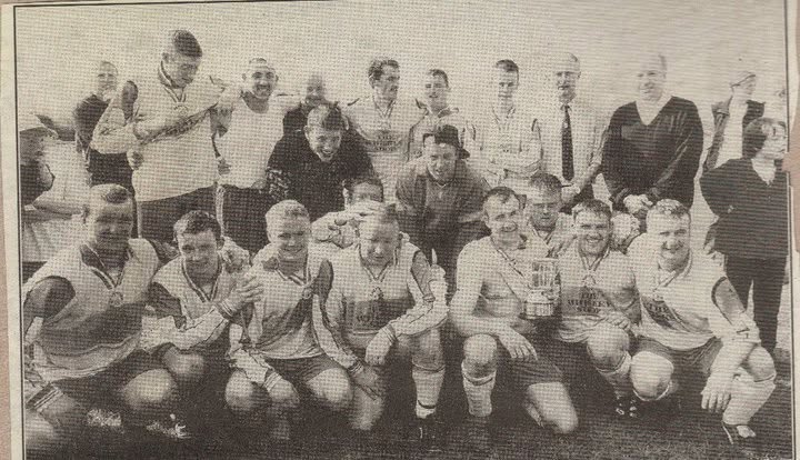 Crettyard United celebrating with a cup and medals