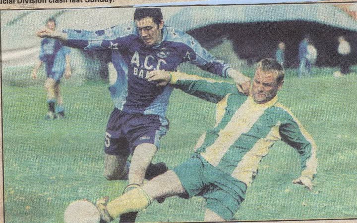 Crettyard United player sliding in to win the ball against an ACC Bank side