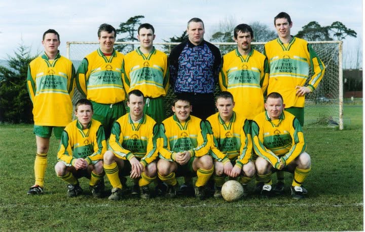 Crettyard United squad in yellow and green The Whiskey Shop kit