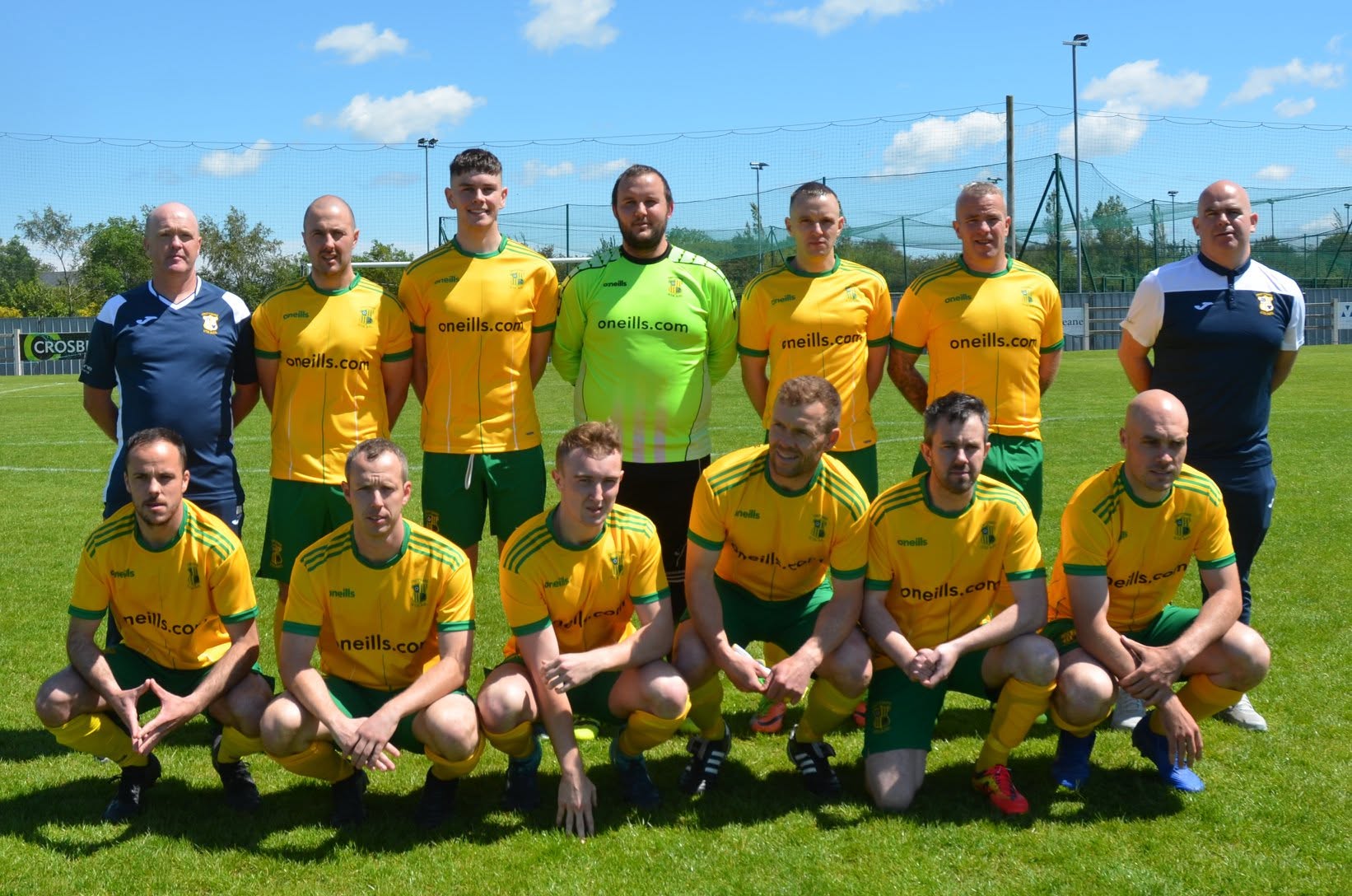 Crettyard United squad photo in yellow O'Neills kit on the astro pitch