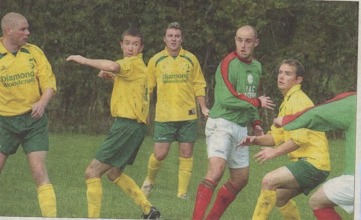 Crettyard United defenders in Diamond Woodcraft kit marking an opponent