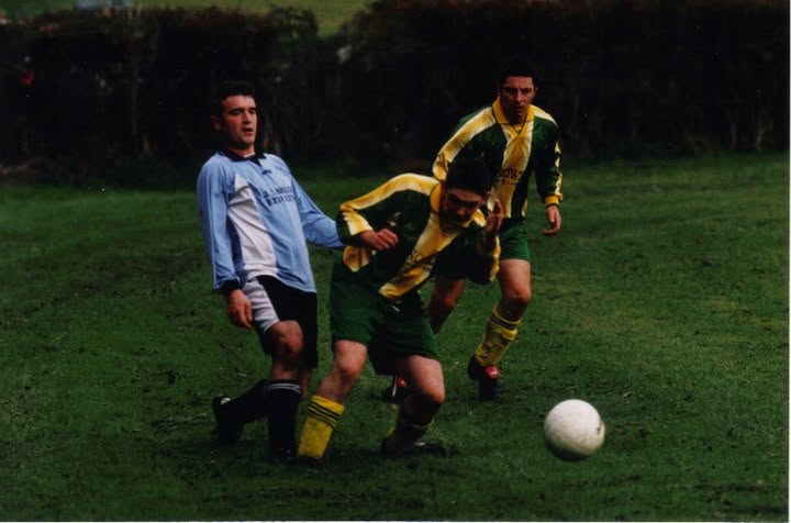 Crettyard United players driving forward past a defender