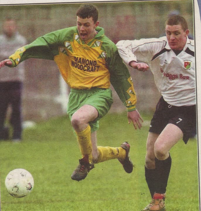 Crettyard United player bursting past a defender in Diamond Woodcraft kit