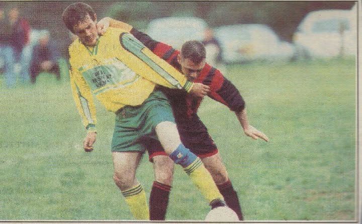 Crettyard United forward being held back by a defender