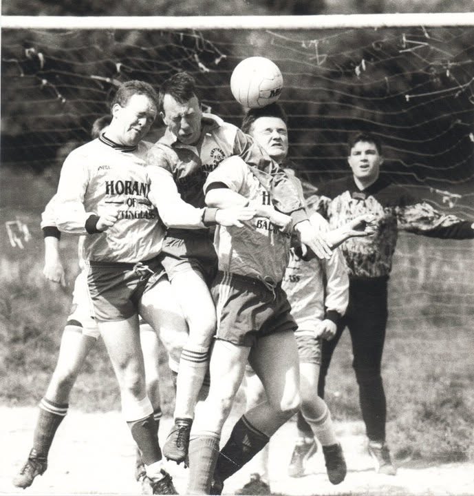 Players contesting a header in the goalmouth