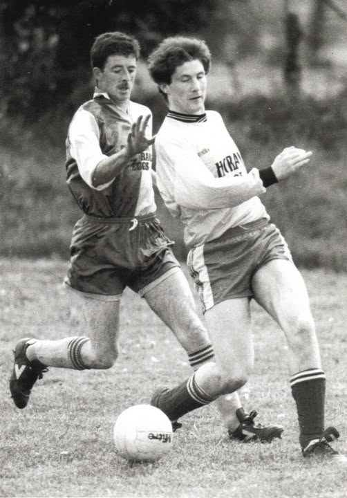 Two players chasing the ball in an old Crettyard United match